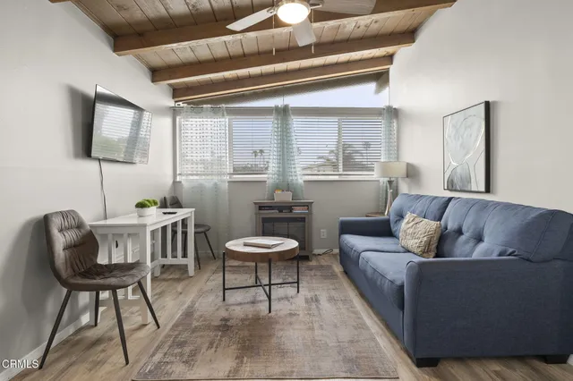 a view of kitchen with furniture and wooden floor
