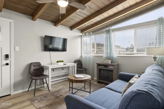 a kitchen with stainless steel appliances granite countertop white cabinets and a stove top oven