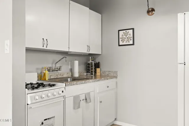 a kitchen with a sink and cabinets