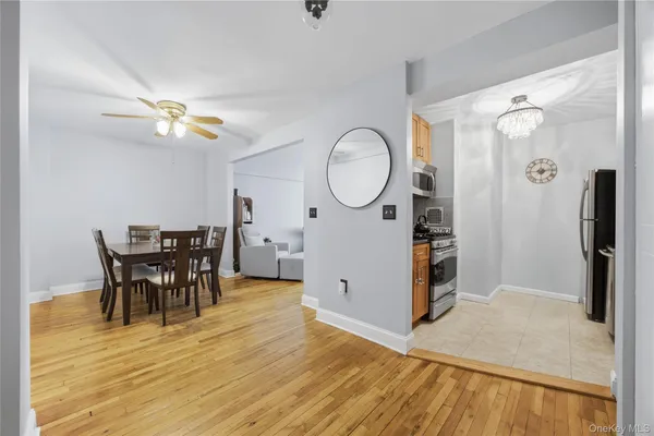 a view of a dining room with furniture and a chandelier