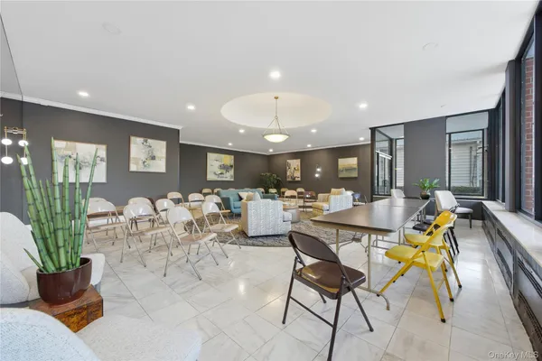 a living room with lots of furniture and a potted plant