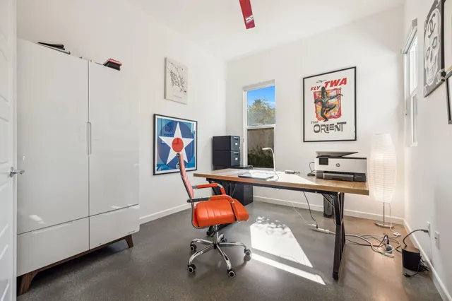 a living room with furniture kitchen view and a flat screen tv