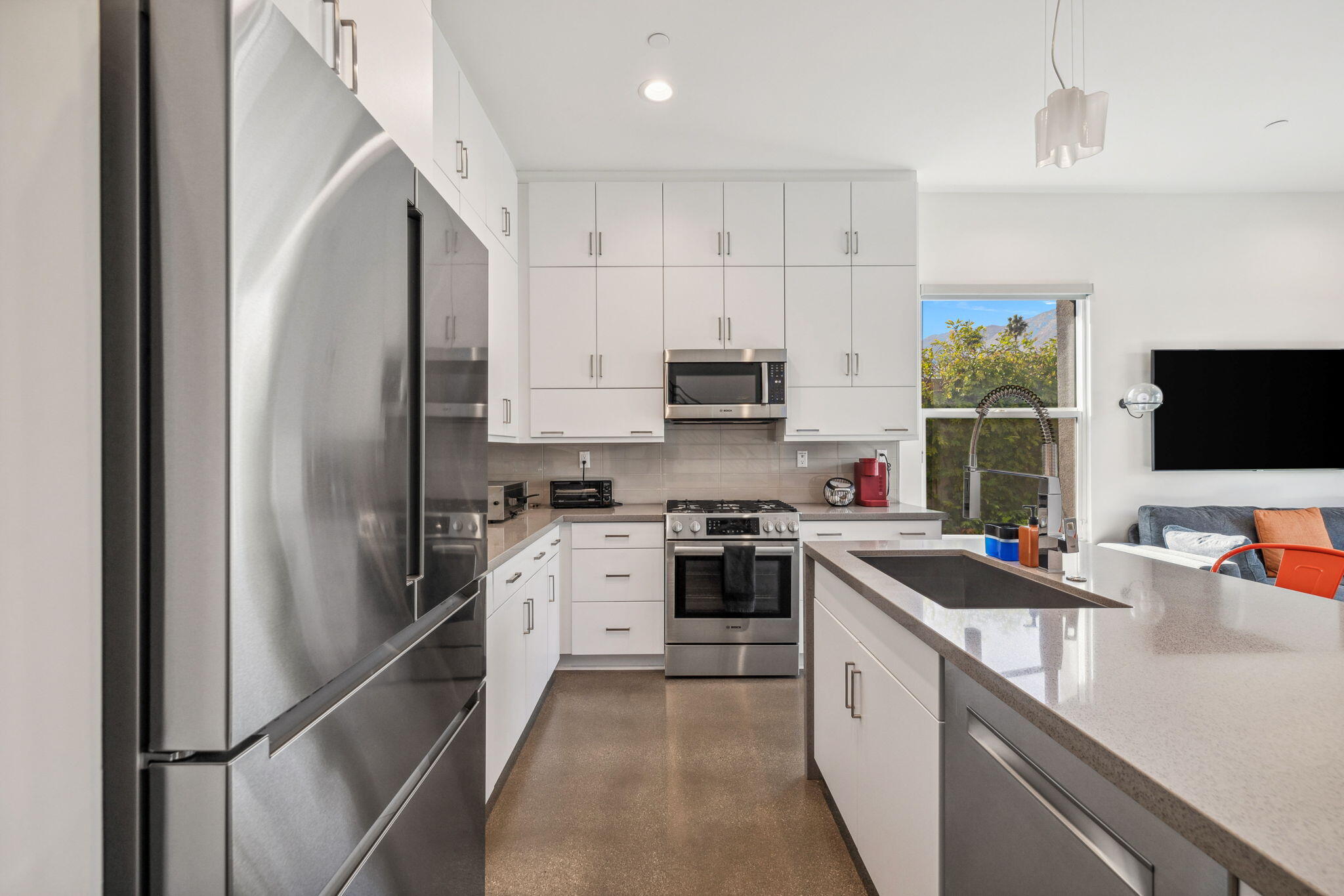 2691 Paragon Loop Palm Springs, CA 92262 - Photo 15 of 18 a kitchen with stainless steel appliances a refrigerator sink and microwave