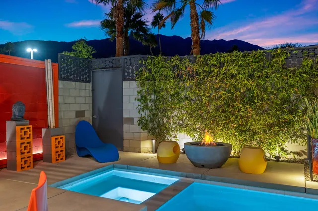 a view of a backyard with plants and a patio
