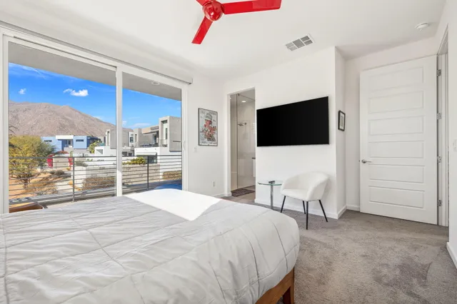 a bedroom with a bed and a flat screen tv