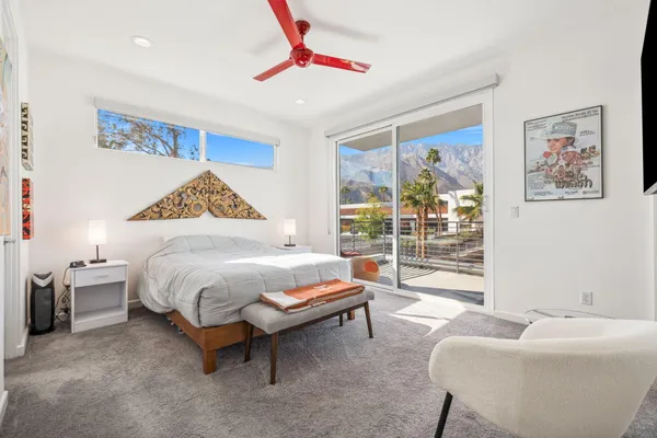 a spacious bedroom with a bed and a couch