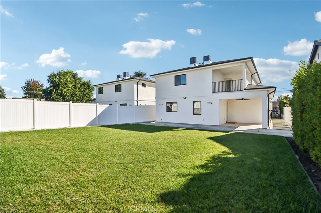 14931 Vose Street Van Nuys, CA 91405 - Photo 35 of 51 a front view of a house with a yard and garage