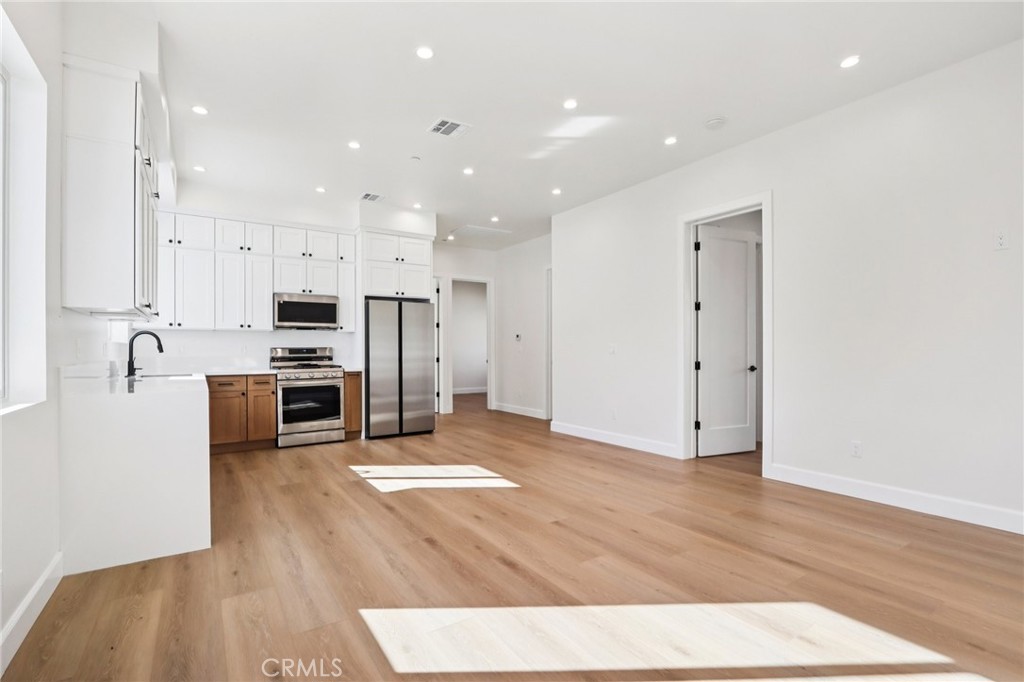 14931 Vose Street Van Nuys, CA 91405 - Photo 39 of 51 a kitchen with stainless steel appliances a refrigerator and a stove top oven