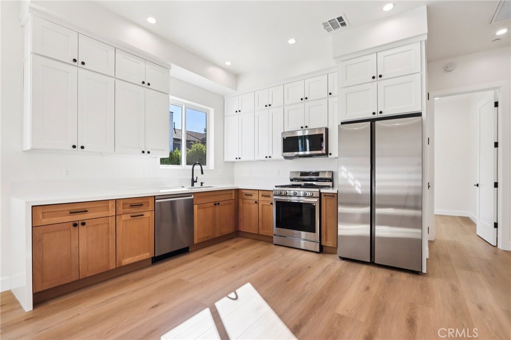 14931 Vose Street Van Nuys, CA 91405 - Photo 41 of 51 a kitchen with granite countertop a refrigerator and a sink