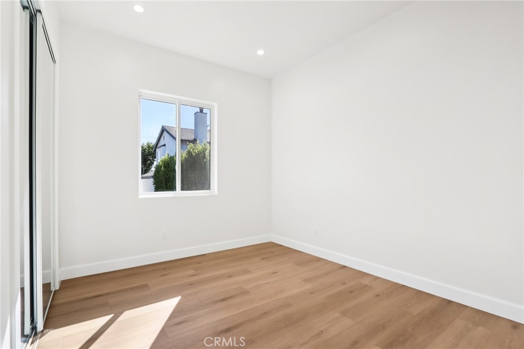 14931 Vose Street Van Nuys, CA 91405 - Photo 49 of 51 a view of an empty room with wooden floor and a window
