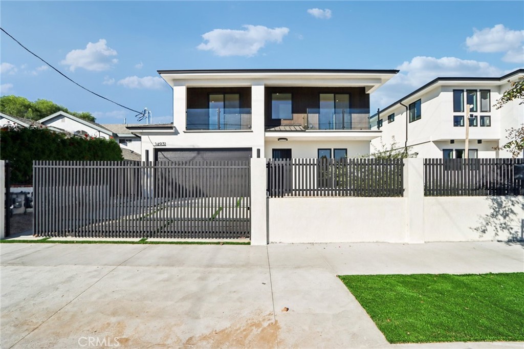 14931 Vose Street Van Nuys, CA 91405 - Photo 5 of 51 a view of a house with a fence and a yard