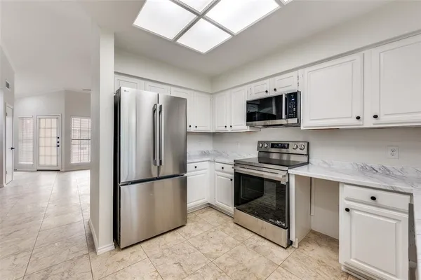 a kitchen with stainless steel appliances granite countertop a refrigerator stove a sink and dishwasher