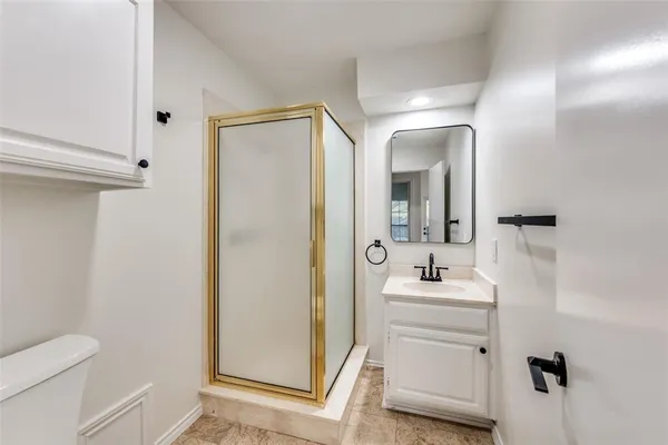 a bathroom with a sink toilet and mirror