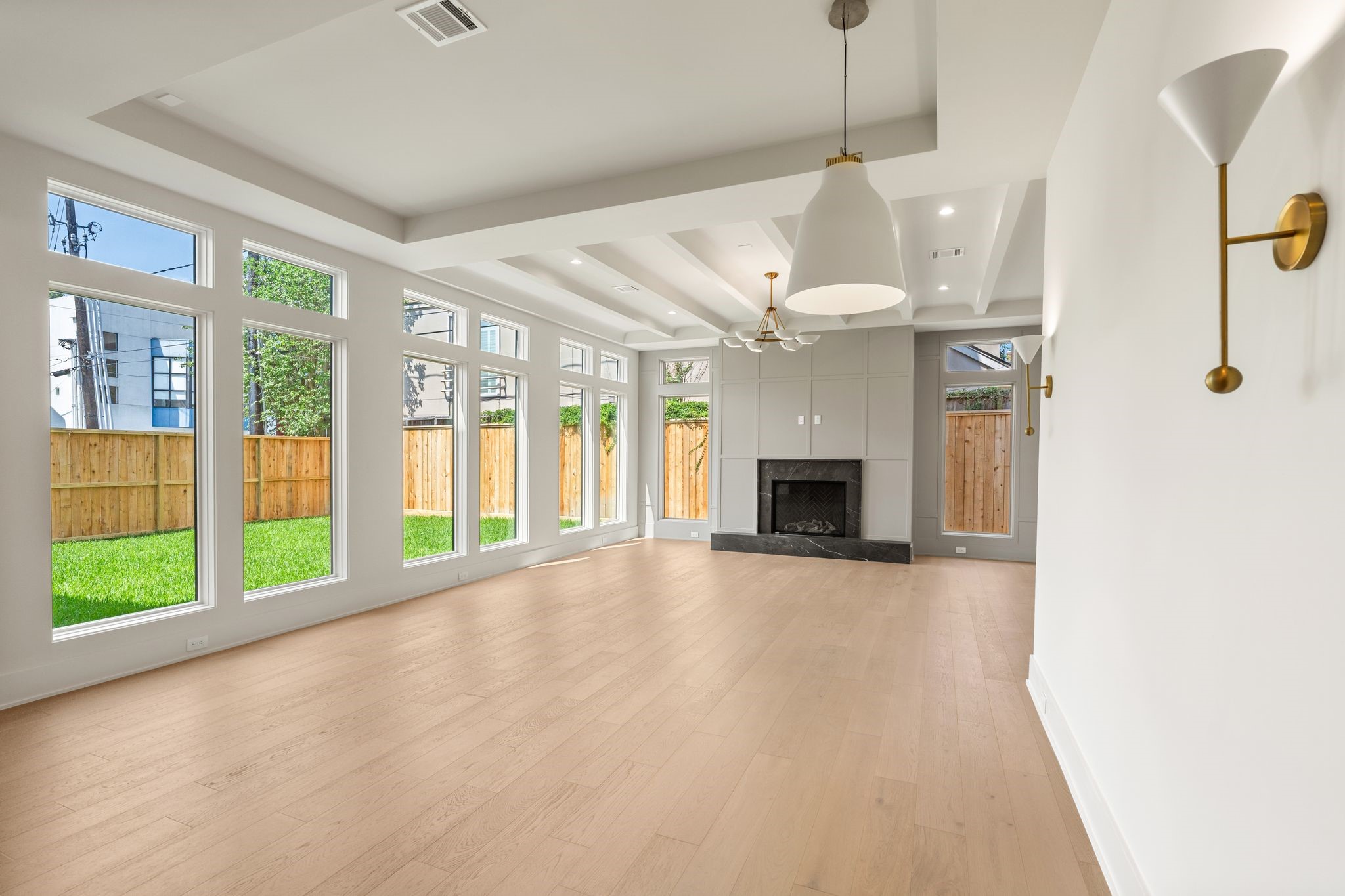 1616 Hazard Street Houston, TX 77019 - Photo 22 of 50 Walls of windows and a gas fireplace make this living room irresistible.