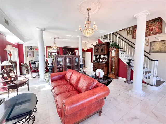 a living room with lots of furniture and a chandelier