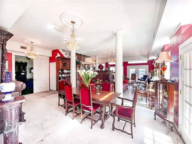 a view of a dining room with furniture and chandelier