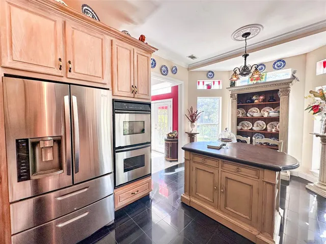 a kitchen with stainless steel appliances a refrigerator and a stove top oven