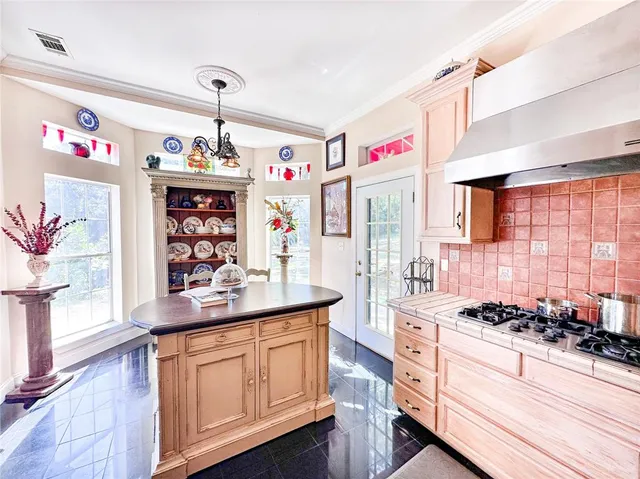 a kitchen with stainless steel appliances cabinets a stove and a window