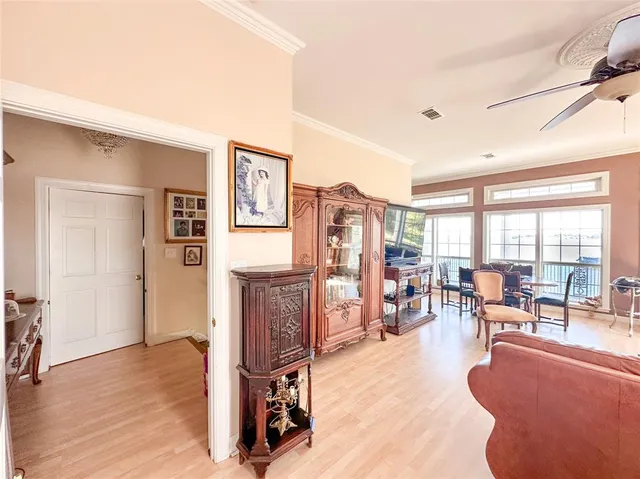 a living room with furniture large window and flat screen tv