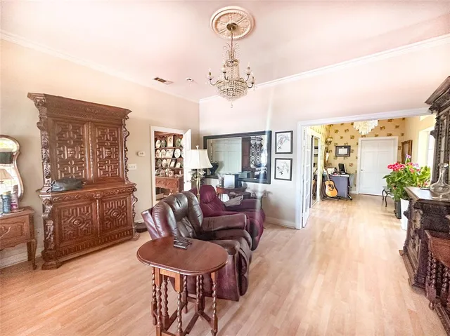 a living room with furniture and a chandelier