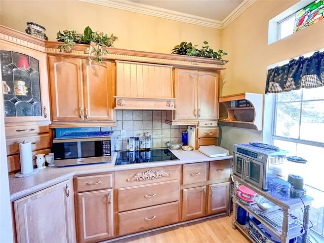 a kitchen with a stove a sink and a microwave