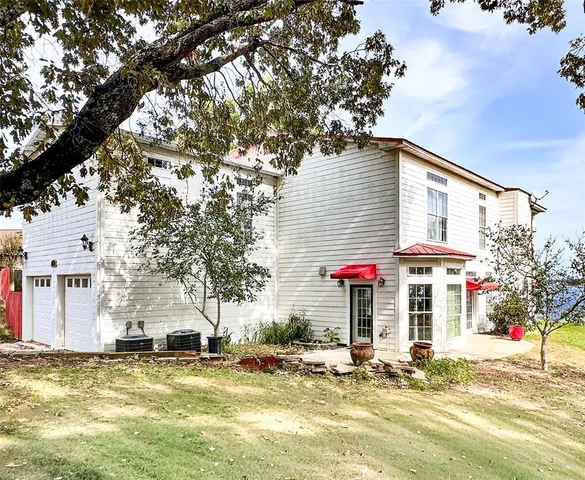 a view of a house with a yard and tree s