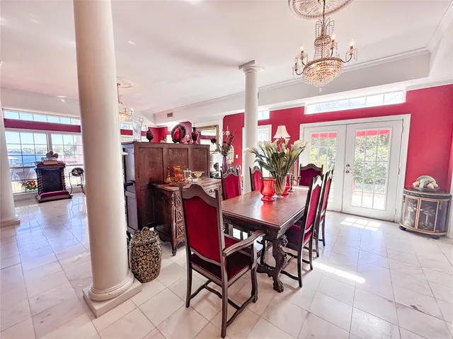a view of a dining room and livingroom with furniture wooden floor a chandelier