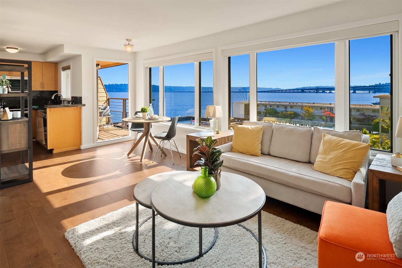 a living room with furniture and a kitchen area