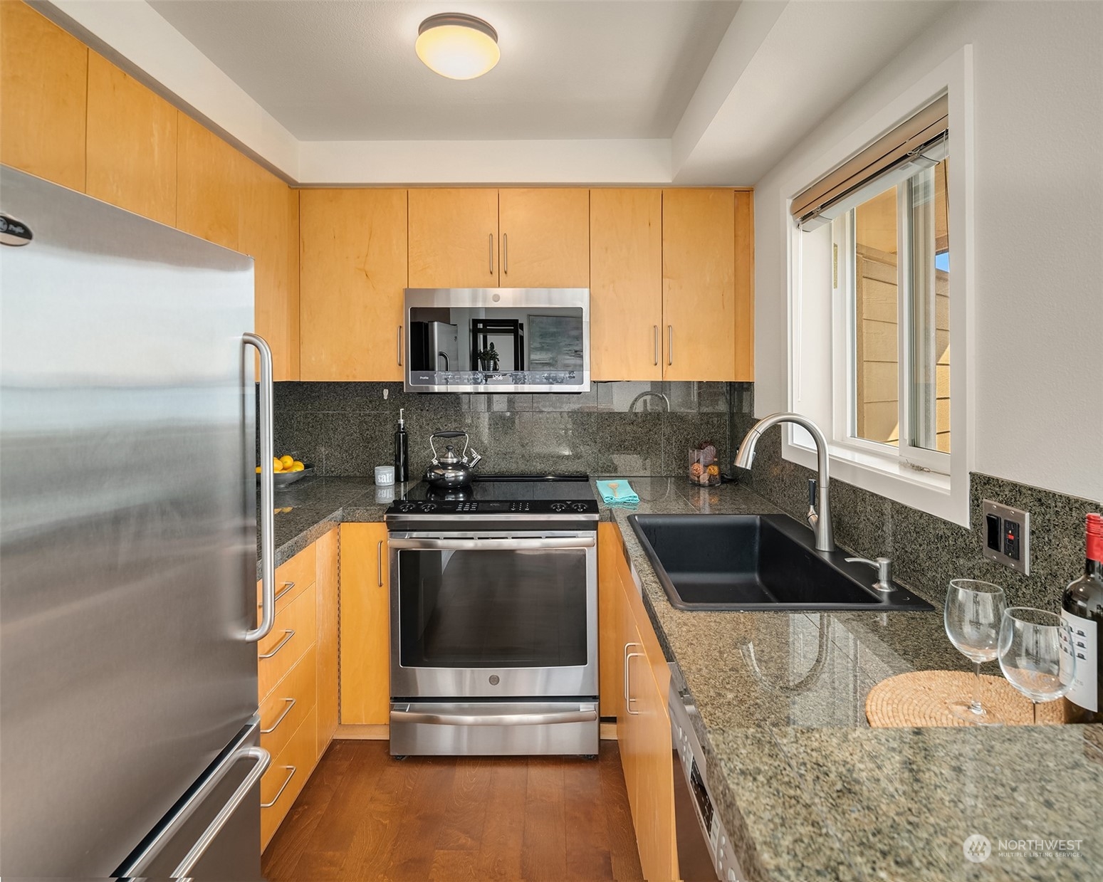 334 Lakeside Avenue South, Unit 401 Seattle, WA 98144 - Photo 11 of 24 a kitchen with stainless steel appliances granite countertop a sink stove and microwave