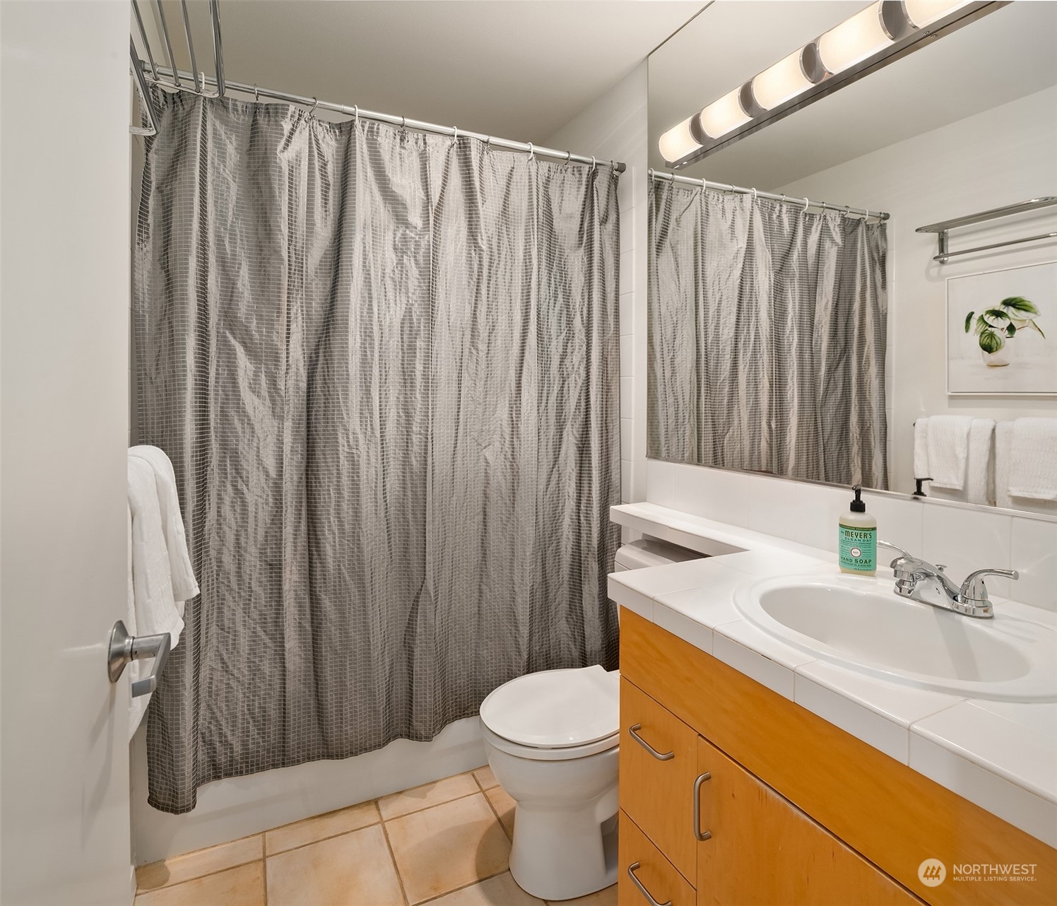 334 Lakeside Avenue South, Unit 401 Seattle, WA 98144 - Photo 14 of 24 a bathroom with a sink a toilet and shower curtain