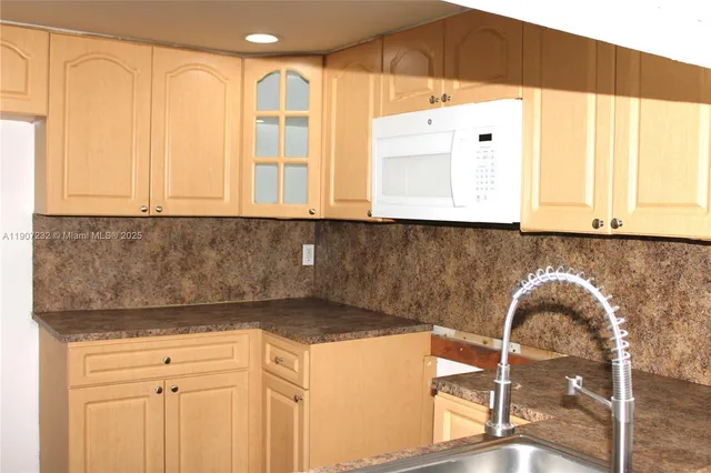 a kitchen with a sink and cabinets