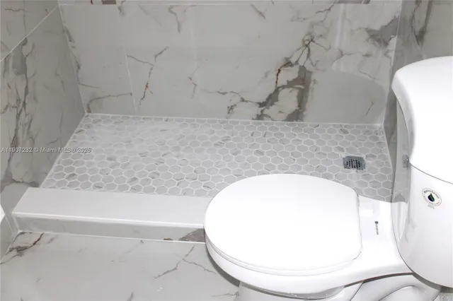 a bathroom with a shower and a mirror