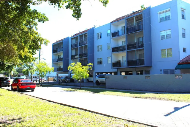 a front view of a building with cars