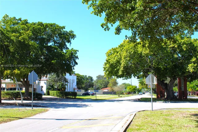 a view of a swimming pool and trees in the background