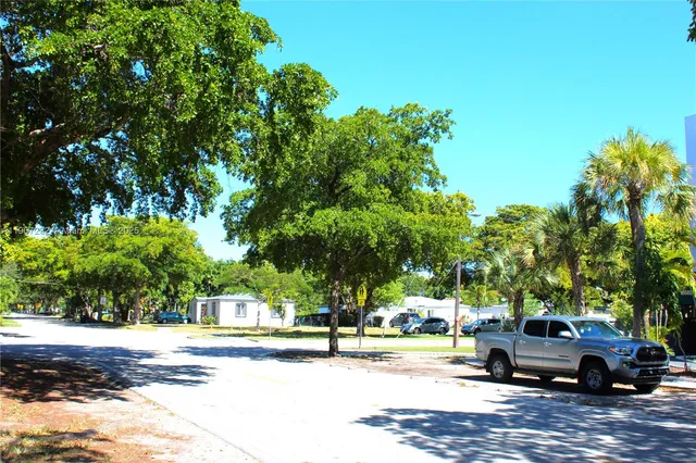 a view of street with parked cars