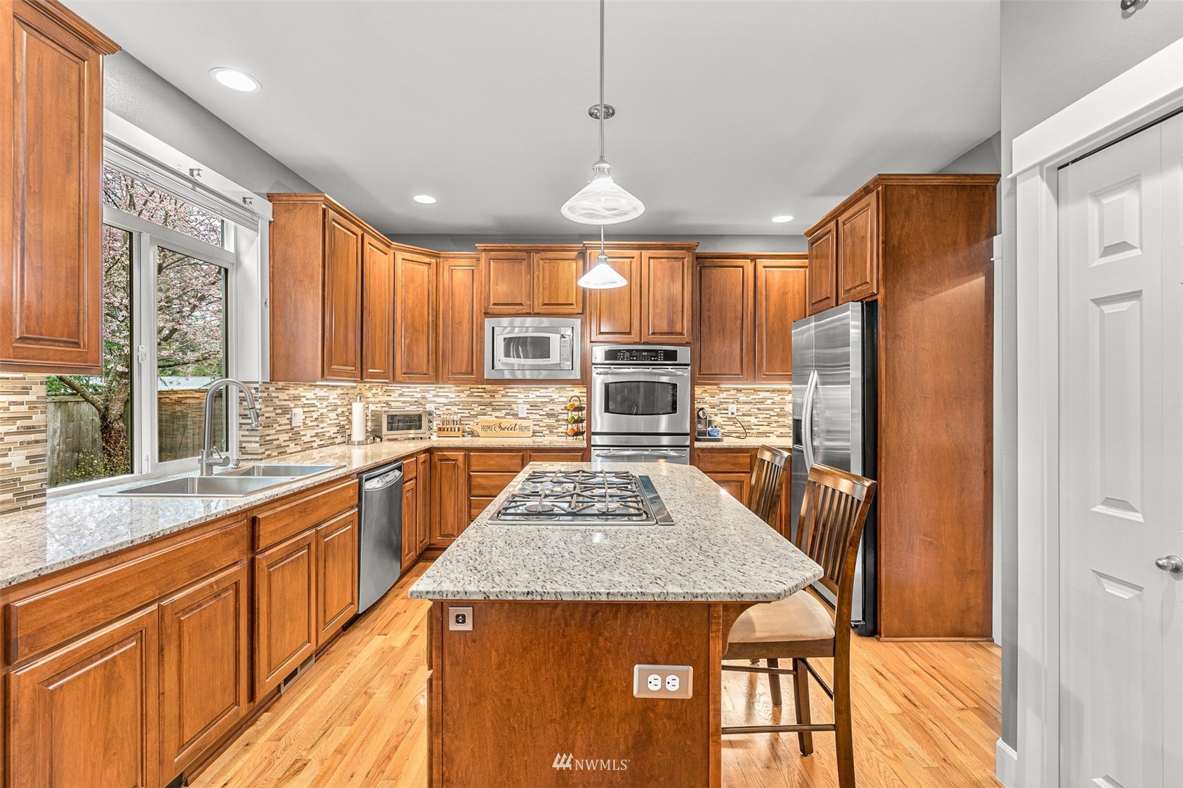 22404 5th Place West Bothell, WA 98021 - Photo 17 of 40 a kitchen with stainless steel appliances granite countertop a sink stove and refrigerator