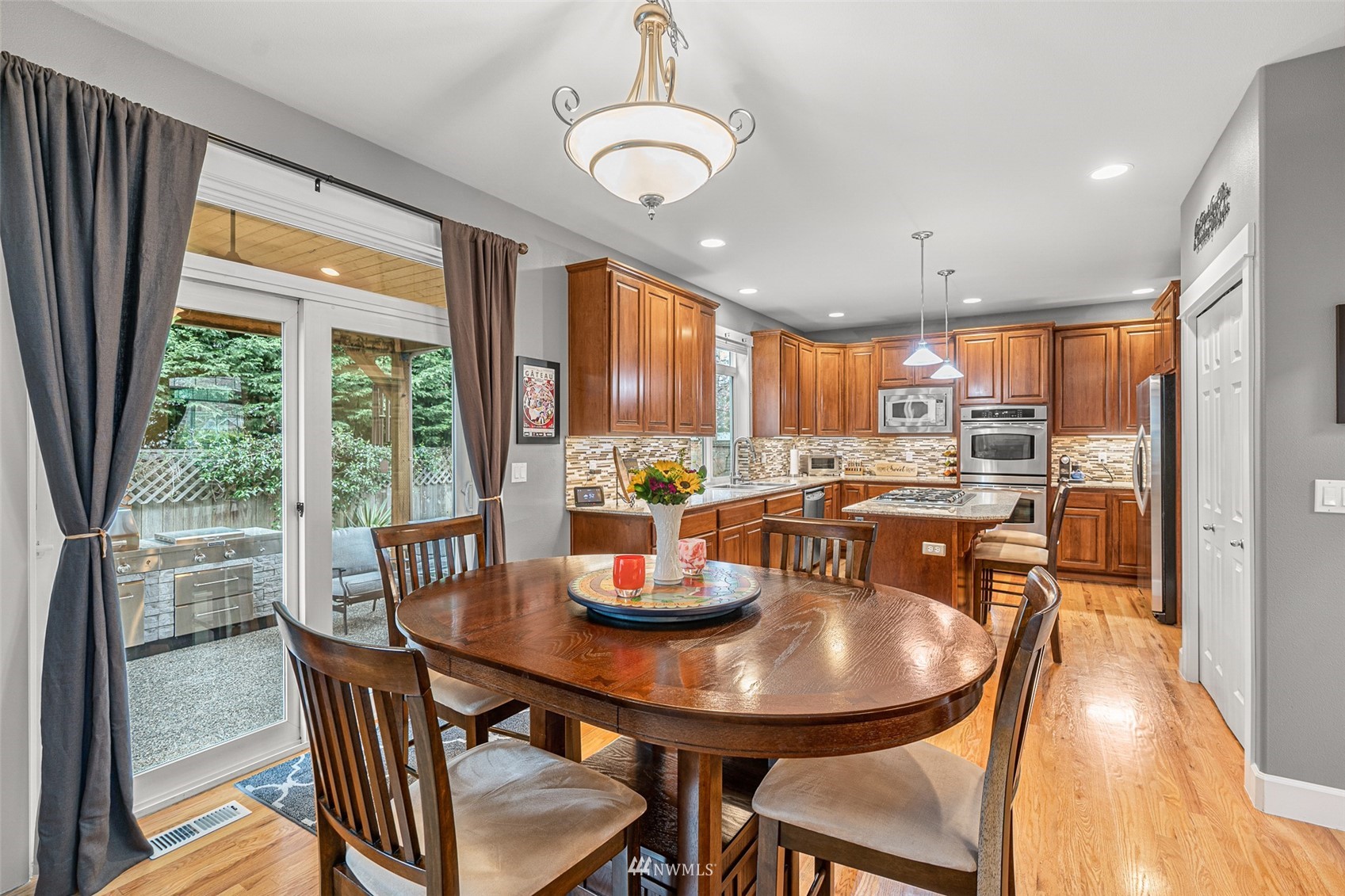 22404 5th Place West Bothell, WA 98021 - Photo 24 of 40 a kitchen with stainless steel appliances granite countertop a dining table and chairs