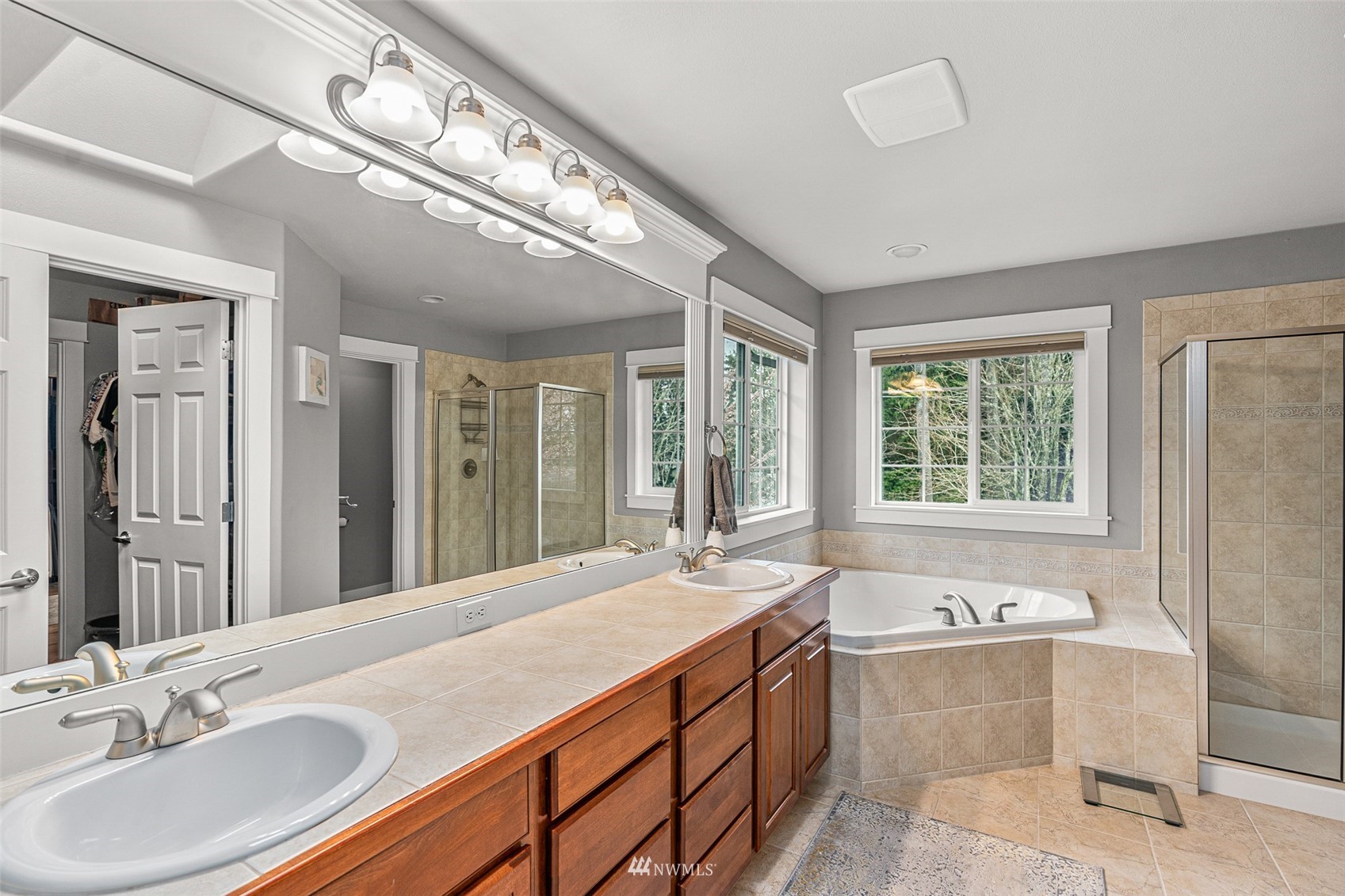 22404 5th Place West Bothell, WA 98021 - Photo 32 of 40 a spacious bathroom with a tub a sink and mirror