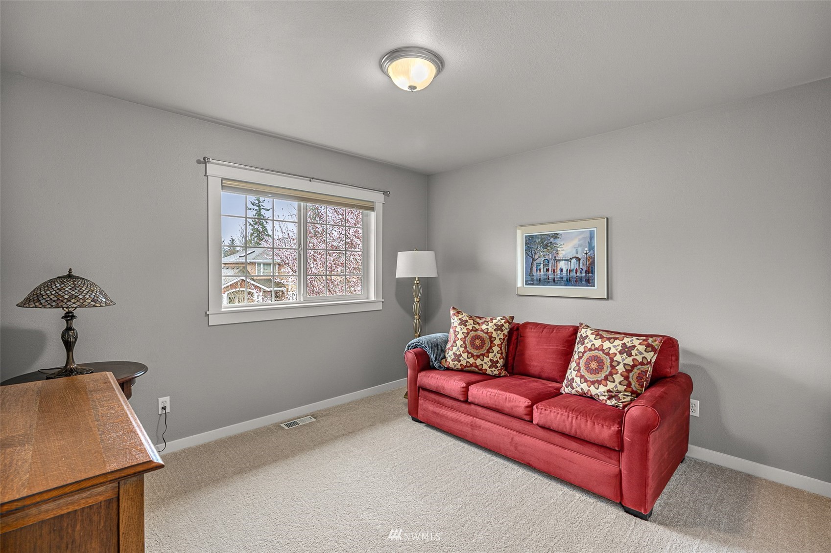 22404 5th Place West Bothell, WA 98021 - Photo 38 of 40 a blue couch sitting in a living room with a window