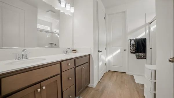 a spacious bathroom with a double vanity sink and mirror