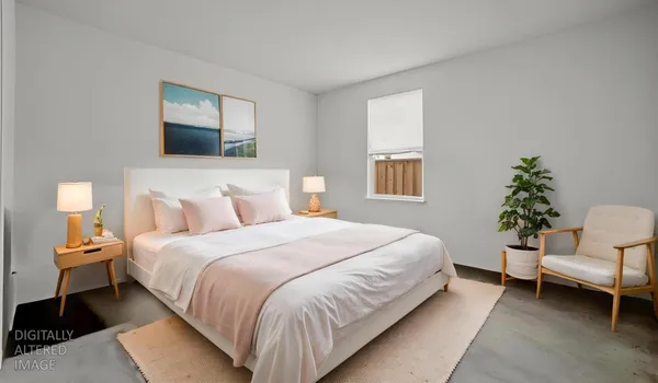 a bedroom with bed and a couch