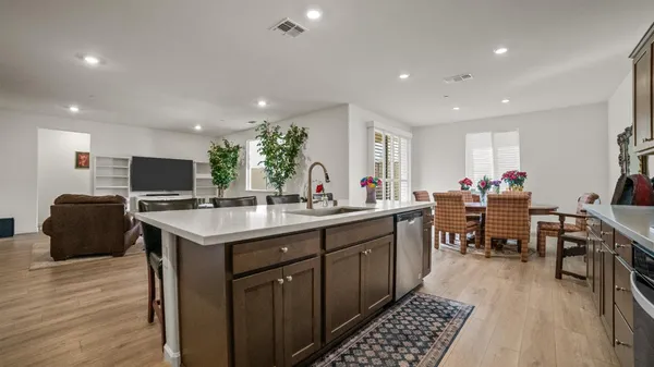 a kitchen with stainless steel appliances kitchen island granite countertop a sink and cabinets