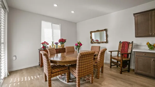 a view of a dining room with furniture and wooden floor