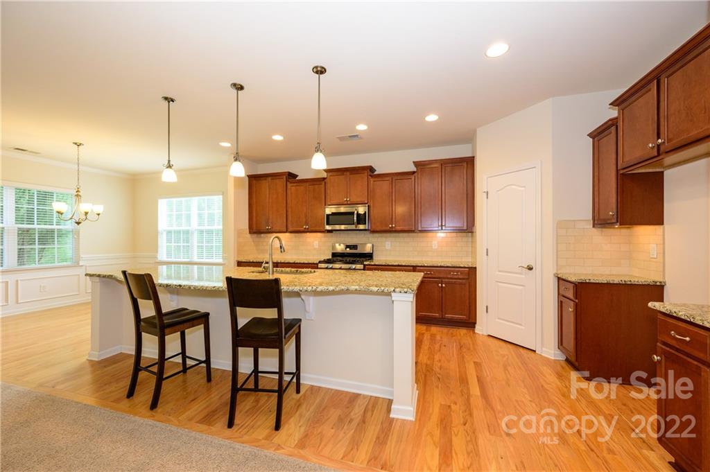 4241 Perth Road Indian Land, SC 29707 - Photo 4 of 34 a kitchen with a table chairs refrigerator and microwave