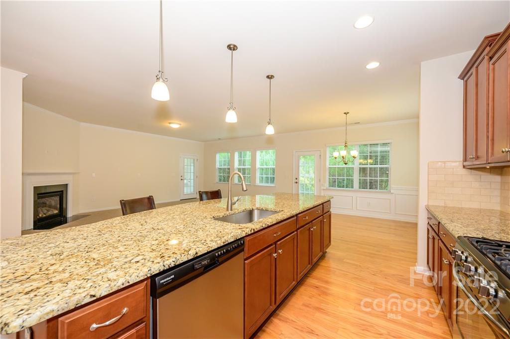 4241 Perth Road Indian Land, SC 29707 - Photo 8 of 34 a large kitchen with kitchen island a sink granite counter tops and a wooden floor