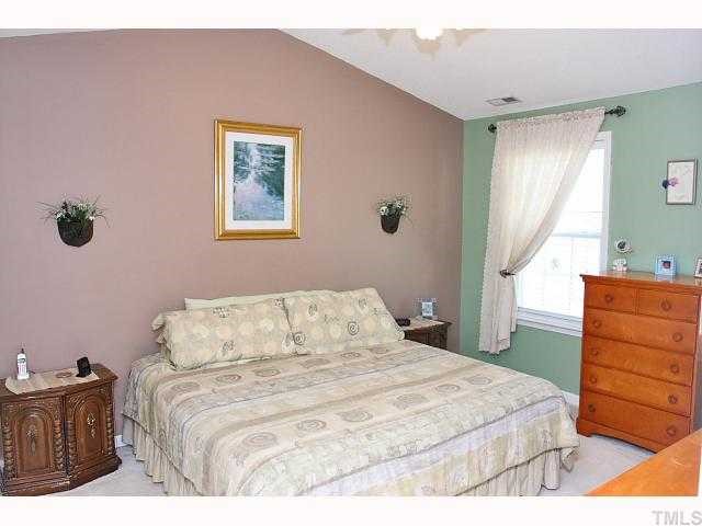 125 Ridge Lake Drive Apex, NC 27539 - Photo 6 of 12 a bedroom with a bed and a dresser