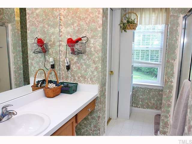 125 Ridge Lake Drive Apex, NC 27539 - Photo 7 of 12 a bathroom with a sink and a mirror