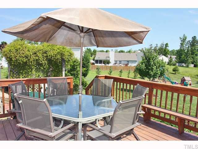 125 Ridge Lake Drive Apex, NC 27539 - Photo 10 of 12 a view of a chair and table on the deck