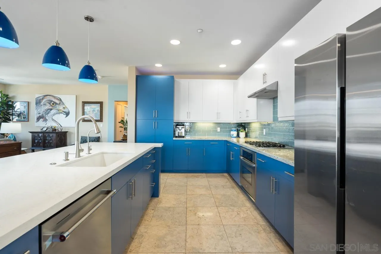 3650 Fifth Avenue, Unit 614 San Diego, CA 92103 - Photo 11 of 62 a large kitchen with stainless steel appliances kitchen island granite countertop a sink and cabinets