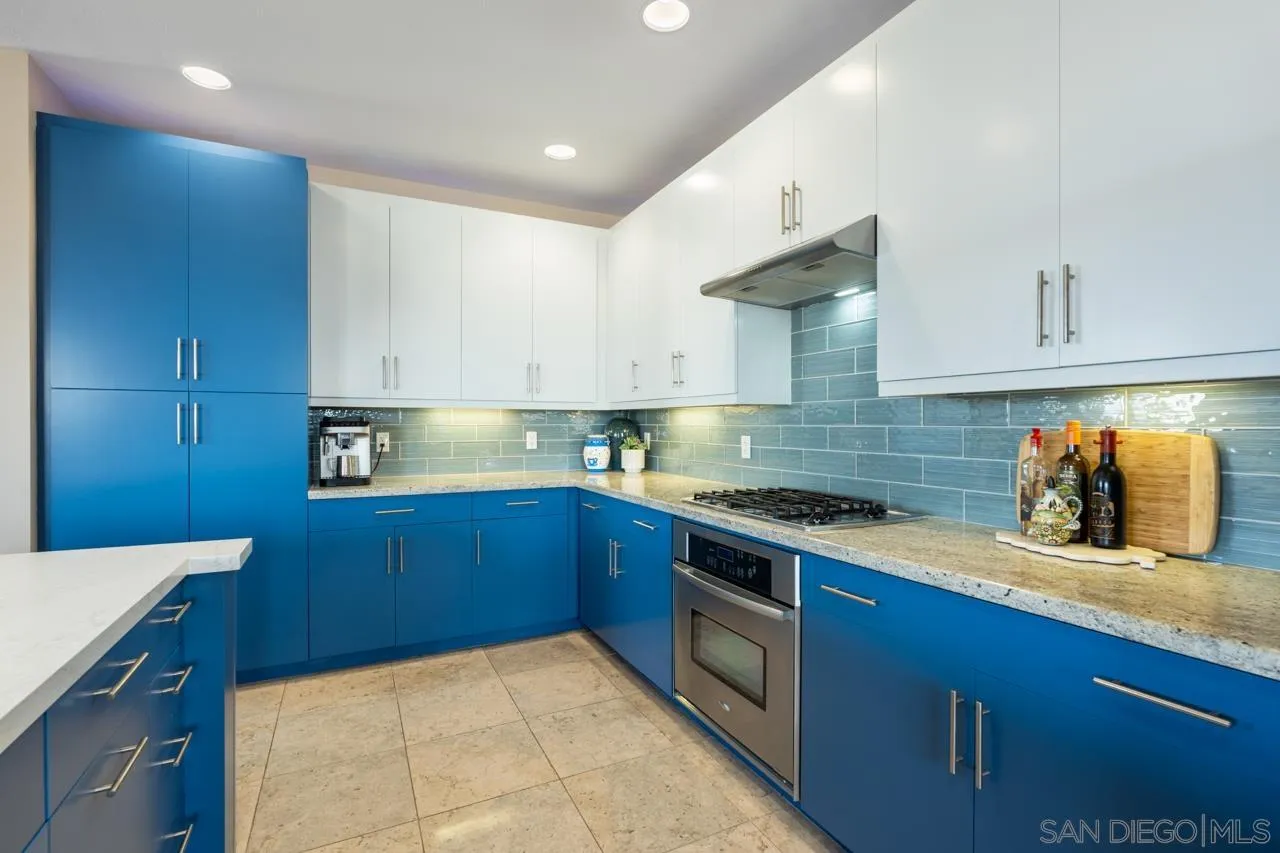 3650 Fifth Avenue, Unit 614 San Diego, CA 92103 - Photo 12 of 62 a kitchen with stainless steel appliances granite countertop a stove a sink and a microwave